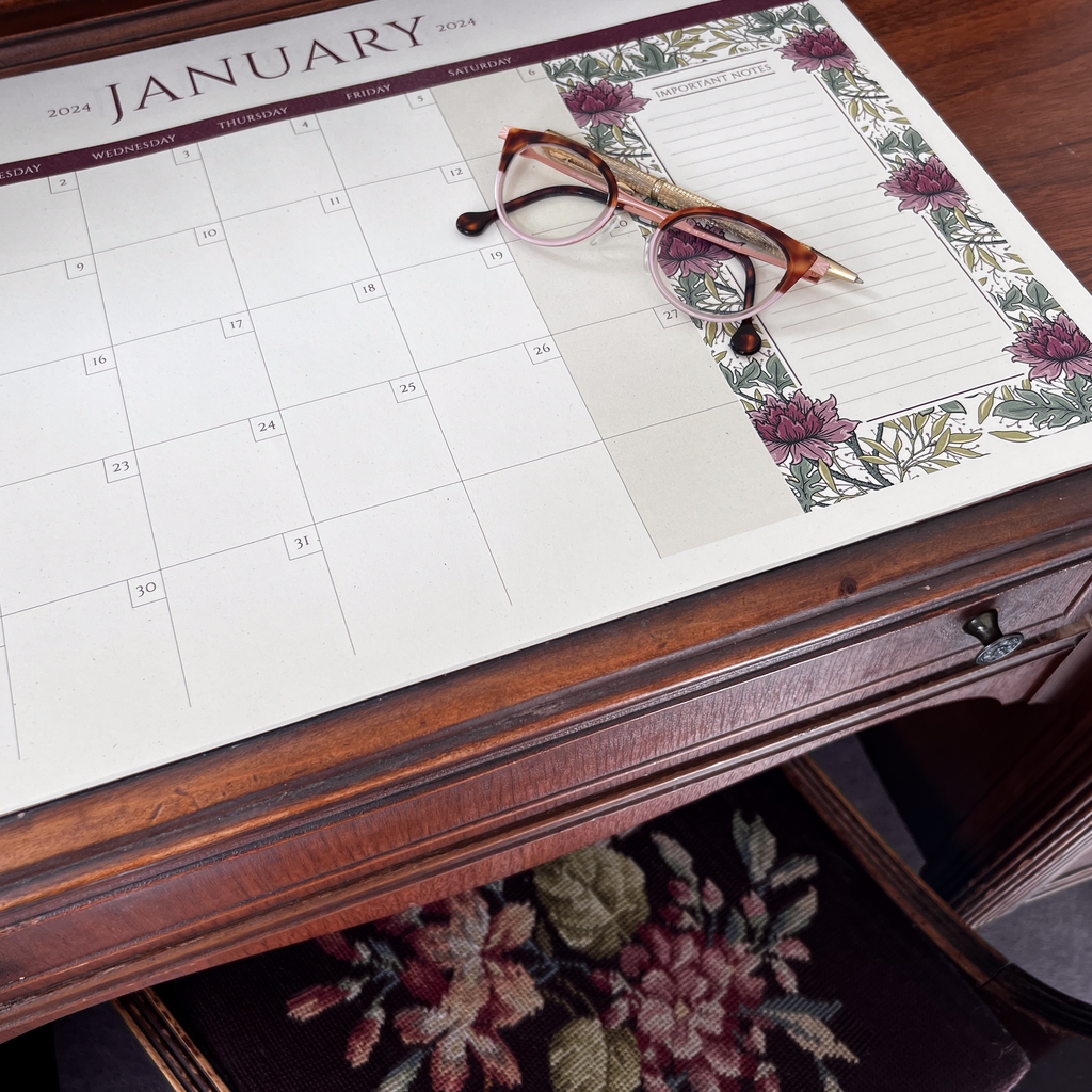 Photo of floral desktop calendar on antique desk